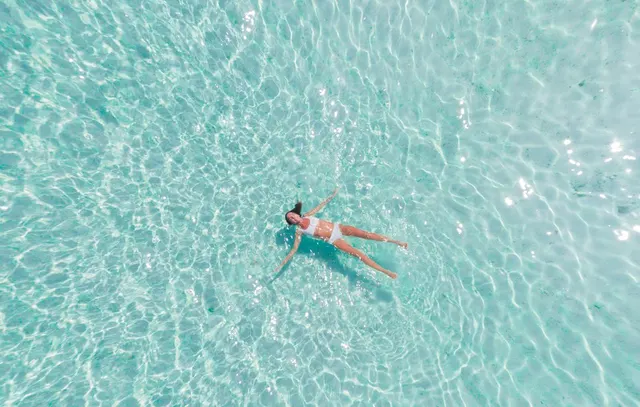 woman swimming on body of water